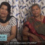 A still from a video featuring caregivers' stories. The still shows two women on a mobile device screen.