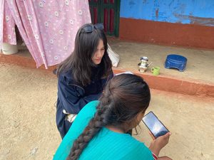 A member of NAMASTE staff conducting evaluation training with a Female Community Health Volunteer (FCHV).